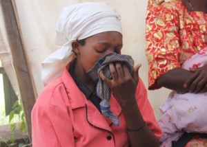 A lady weeps at Mulago Hospital