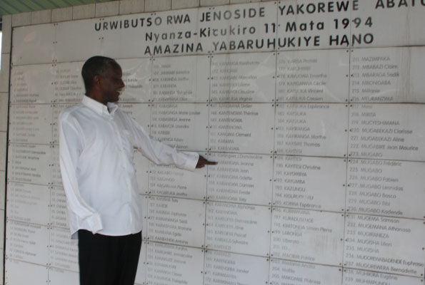 Venuste Karasira points at the list of people who were killed in Nyanza, Kicukiro District in Rwanda. He is among the people who survived that mass killing. PHOTO BY FAUSTIN MUGABE