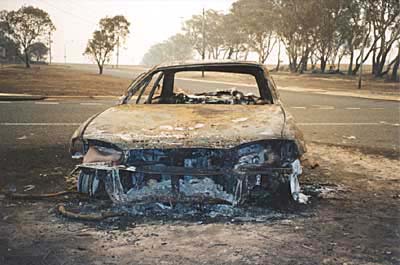 The occupants of this car had gone to the aid of a friend to help evacuate their home in Chapman, when the firestorm hit. As they rushed to escape in the car, it  caught fire and they had to run for their lives. photo: Christine Ashley-Coe