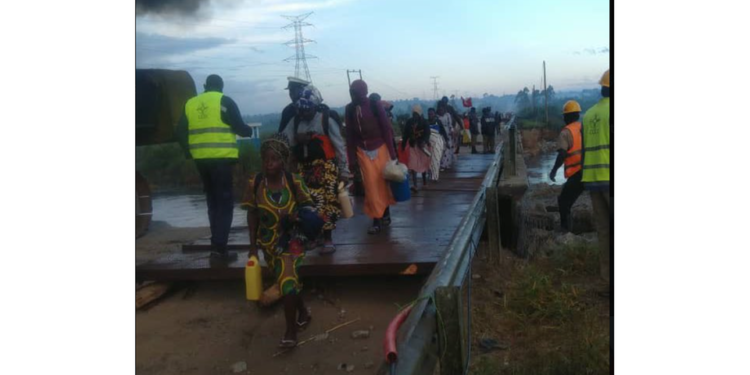 Pilgrims tipped on safety as they cross temporary bridge at Katonga
